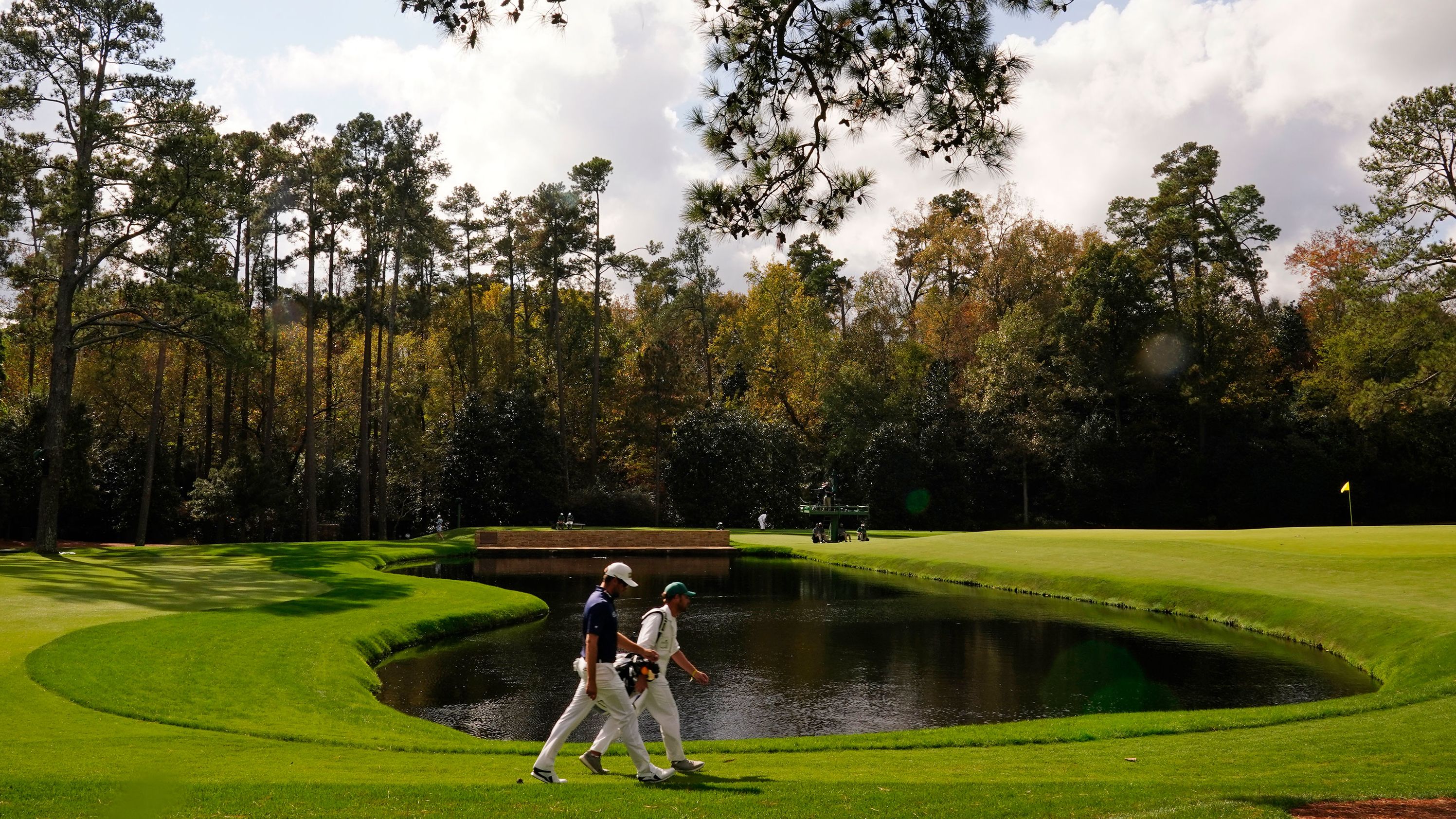 Corey Conners, of Canada, walks with his caddie Kyle Peters on the 15th fairway during the final round.