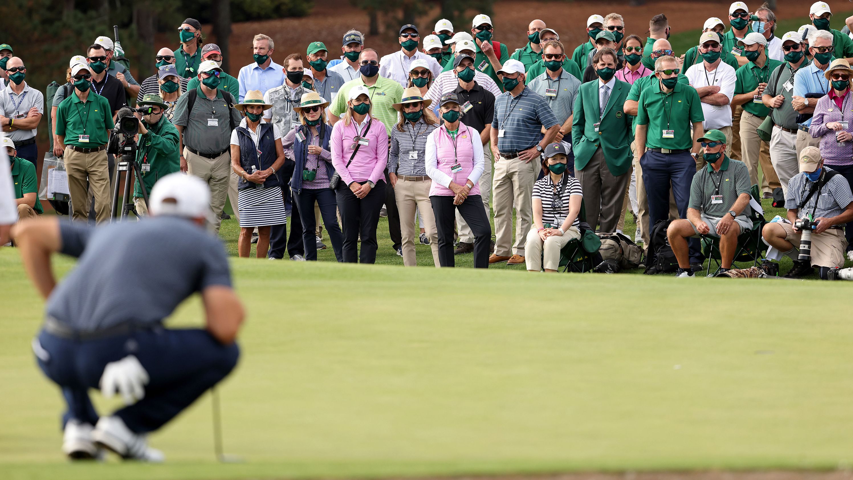 A view of the gallery as Dustin Johnson of the United States lines up a putt on the 18th green before claiming victory.
