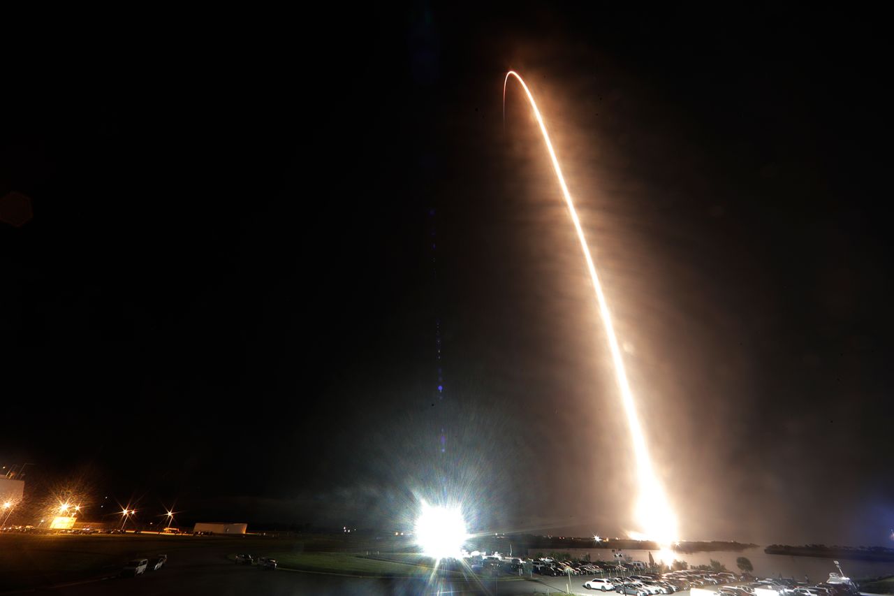 A Falcon 9 SpaceX rocket with the Crew Dragon capsule is seen in this  long-exposure photo as it lifts off from Kennedy Space Center.