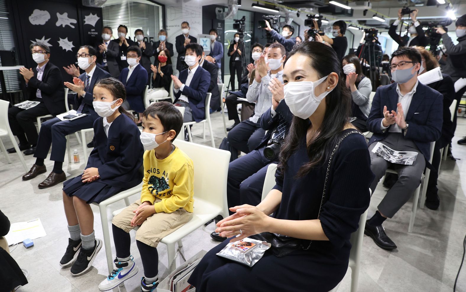 People watch the Crew Dragon launch in Tokyo on November 16.