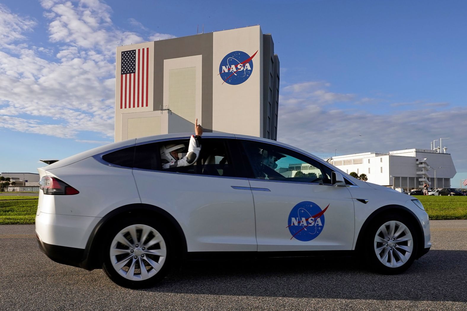 Noguchi sticks his arm out the window while riding to Launch Pad 39A for liftoff.