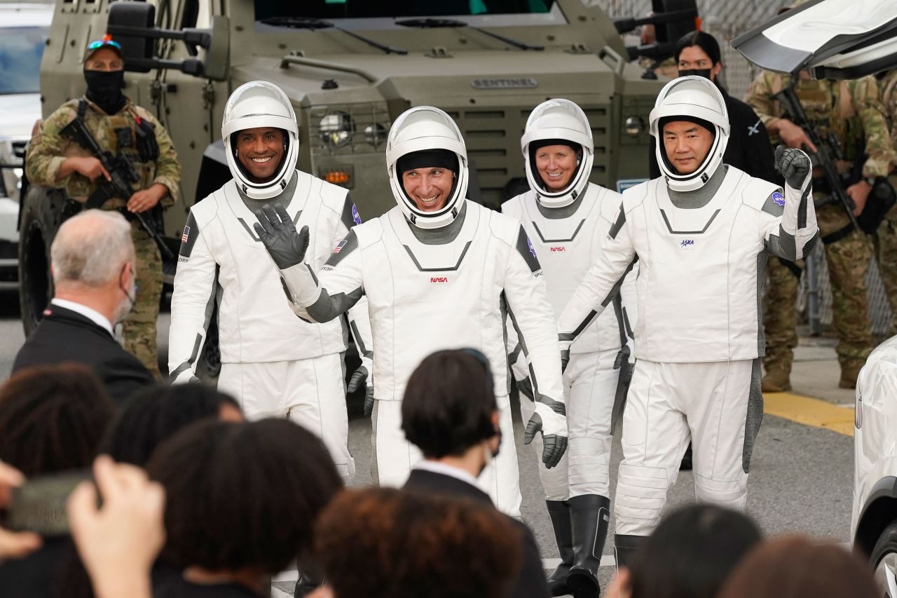 Glover, Hopkins, Walker and Noguchi wave as they leave the Operations and Checkout Building.