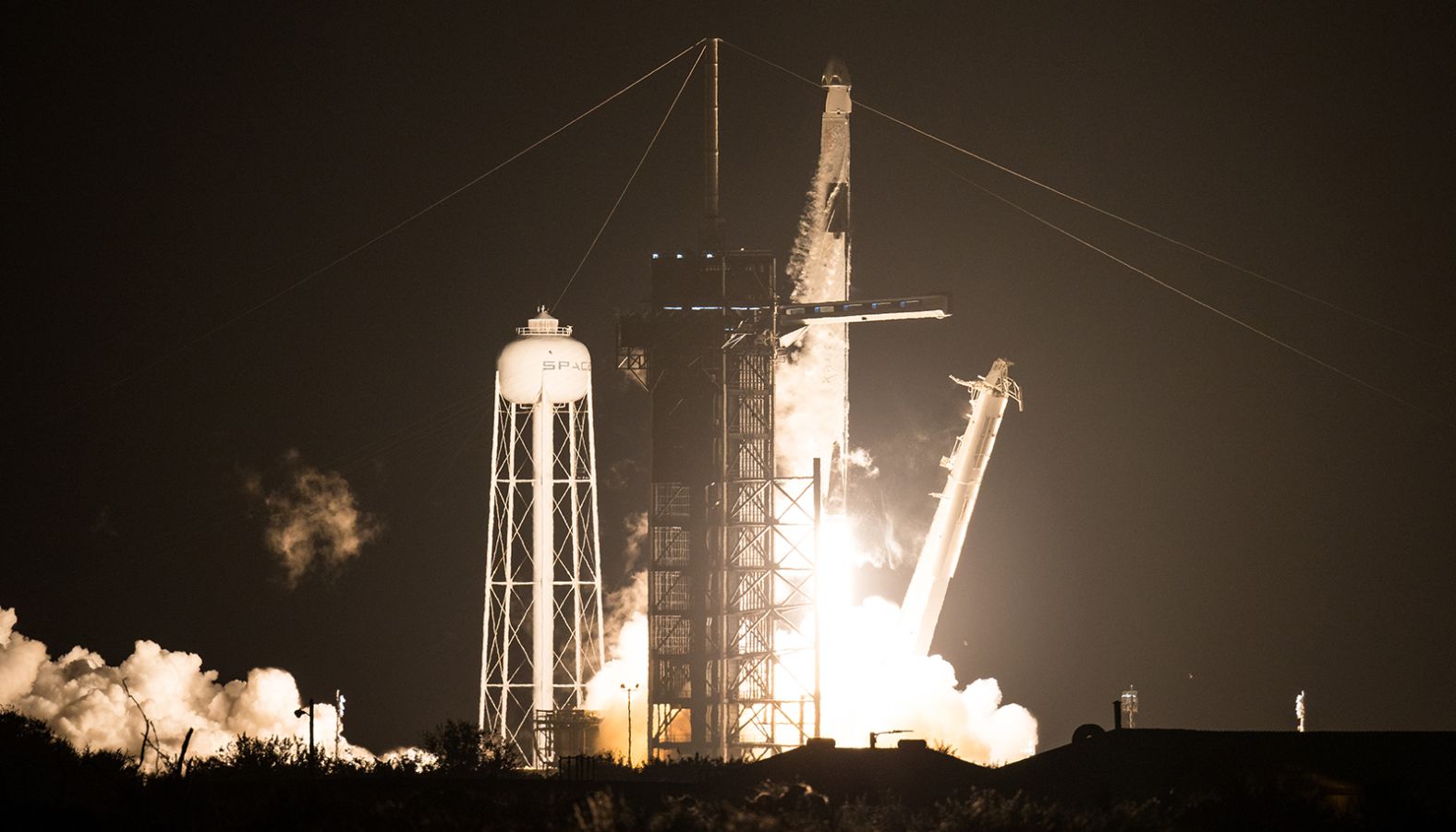 A SpaceX Falcon 9 rocket carrying the company's Crew Dragon spacecraft lifts off for the International Space Station.