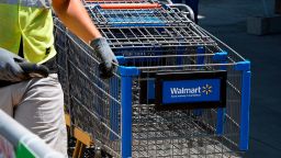 An employee gathers shopping carts at Walmart, July 22, 2020 in Burbank, California. - The country's most populous state reported a record 12,807 new coronavirus infections in the past 24 hours. (Photo by Robyn Beck/AFP/Getty Images)