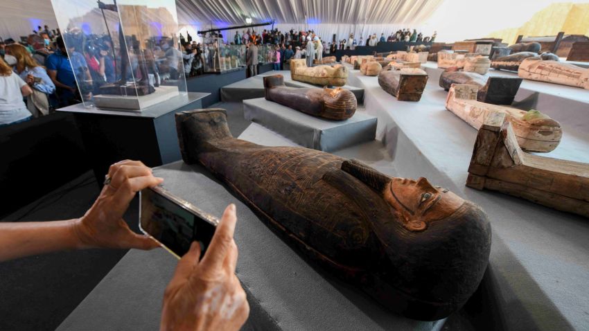 A picture shows wooden sarcophagi on display during the unveiling of an ancient treasure trove of more than a 100 intact sarcophagi, at the Saqqara necropolis 30 kms south of the Egyptian capital Cairo, on November 14, 2020. - Egypt announced the discovery of an ancient treasure trove of more than a 100 intact sarcophagi, the largest such find this year. The sealed wooden coffins, unveiled on site amid fanfare, belonged to top officials of the Late Period and the Ptolemaic period of ancient Egypt. They were found in three burial shafts at depths of 12 metres (40 feet) in the sweeping Saqqara necropolis south of Cairo. (Photo by Ahmed HASAN / AFP) (Photo by AHMED HASAN/AFP via Getty Images)