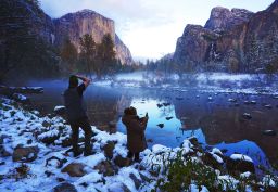 Erick Jensen (left), of Seattle, and Ruth Reyes (right), of LA, take in the Yosemite Valley November 9, following the weekend's snowstorm in Yosemite National Park, California.
