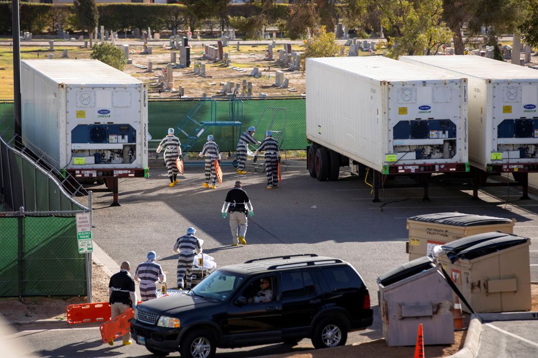 Inmates help move bodies to refrigerated trailers in El Paso County, Texas.