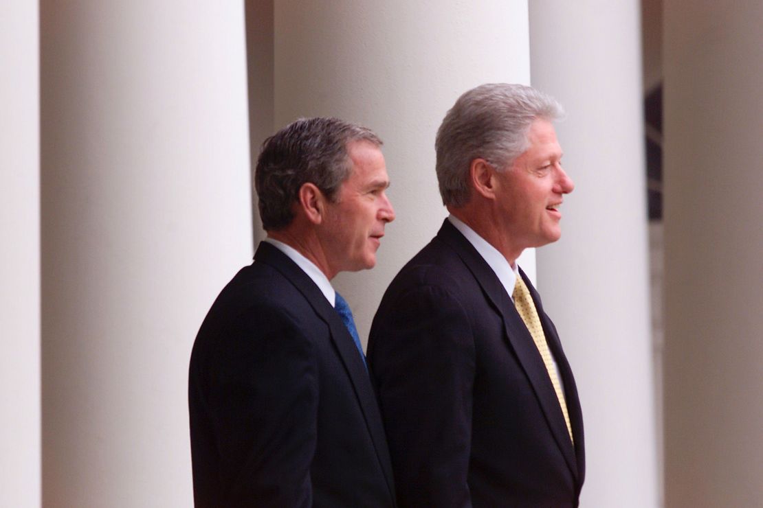 President Bill Clinton and President-elect George W. Bush stand outside the White House for their first meeting since the election December 19, 2000, in Washington, D.C.