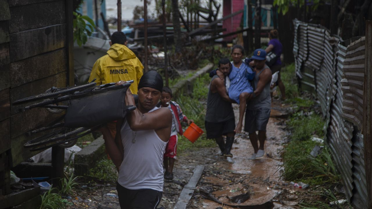 Local villagers carry a woman during an evacuation ahead of landfall of Hurricane Iota on November 16, 2020 in Puerto Cabezas, Nicaragua.
