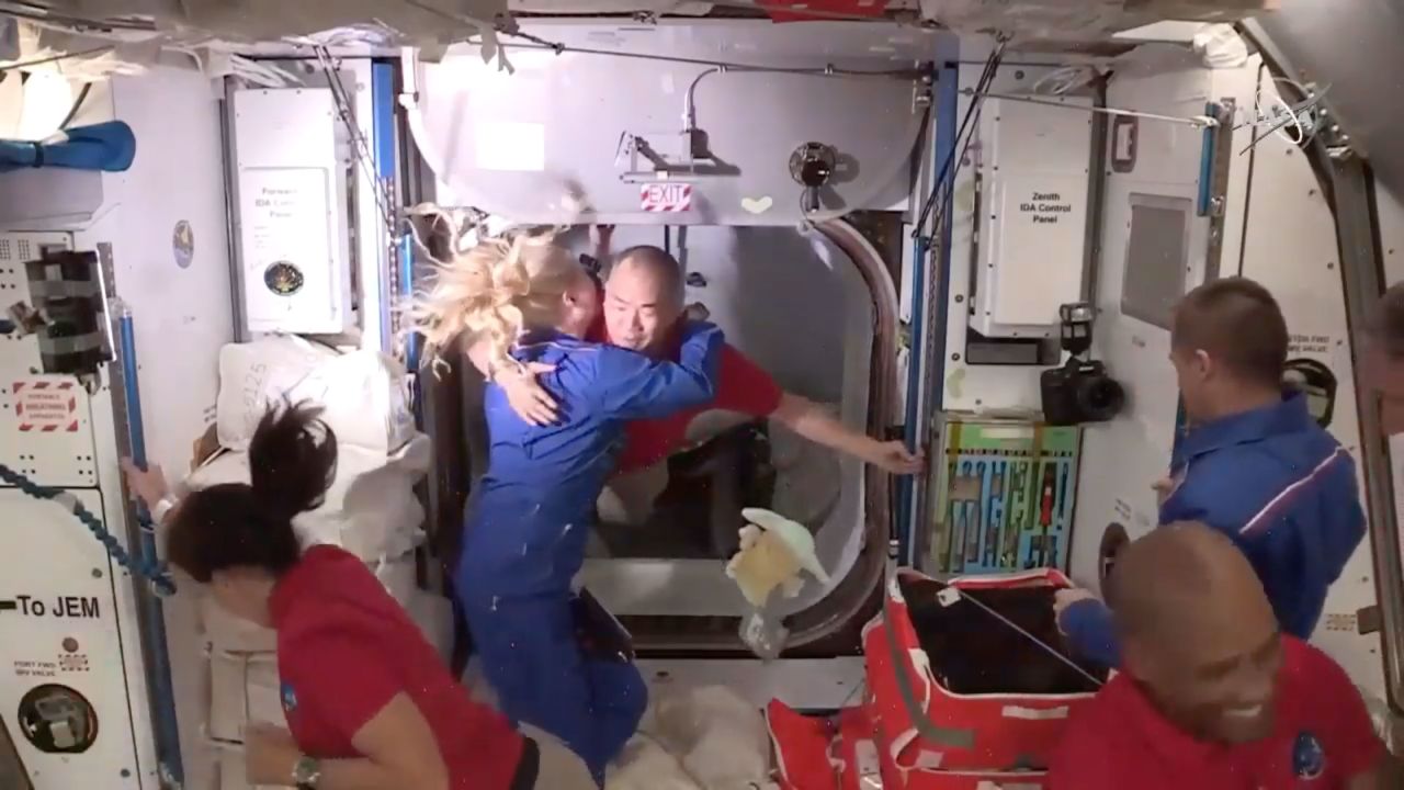 Kate Rubins, who was already on board the International Space Station, greets Noguchi and the rest of the team with a hug.