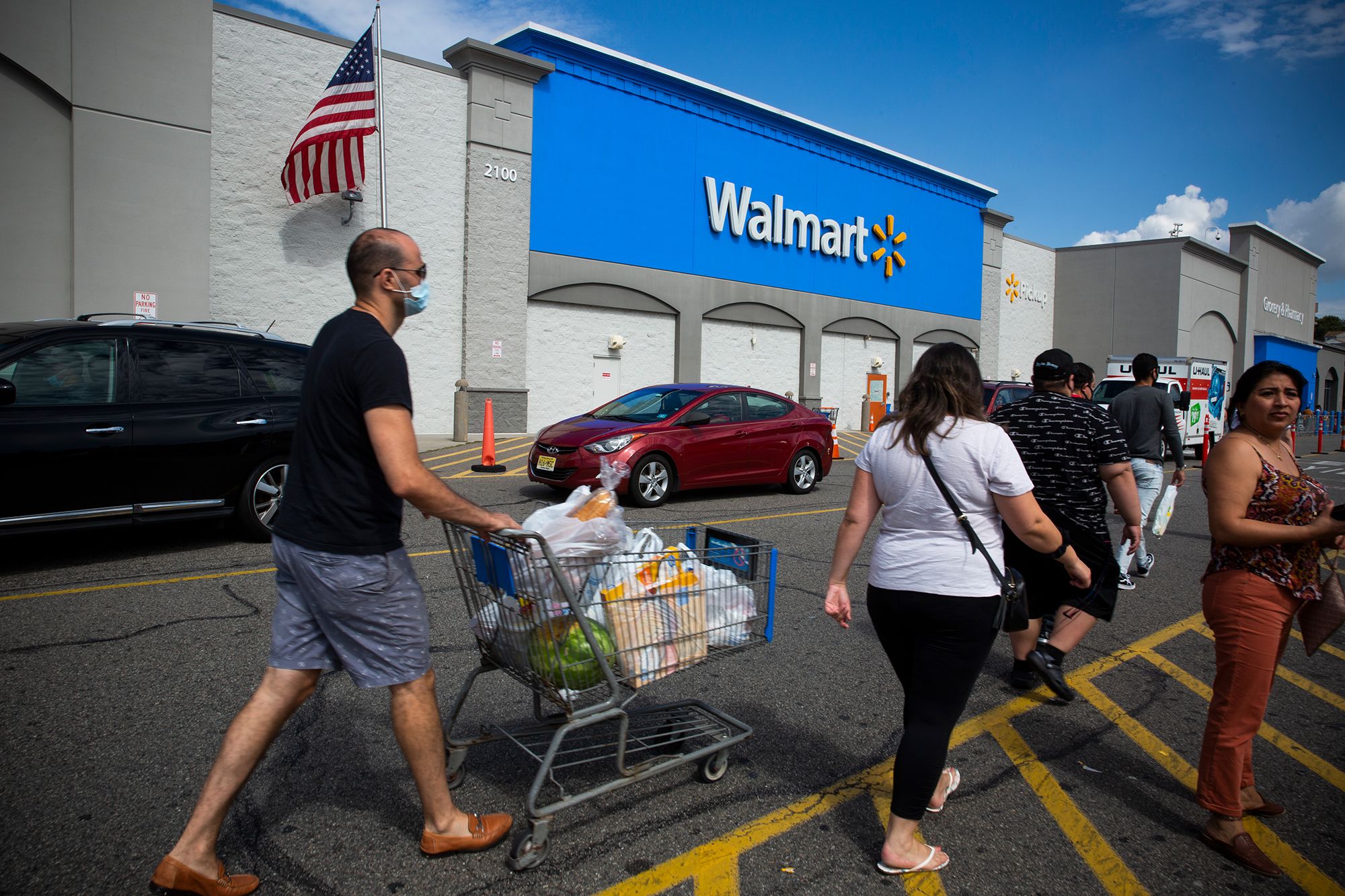 Miami, FL, USA - March 26, 2020: People Going In A Walmart Store On Sunny  Day. Walmart Is The World's Third Largest Public Corporation That Runs  Chains Of Department Stores. Quarantine Due