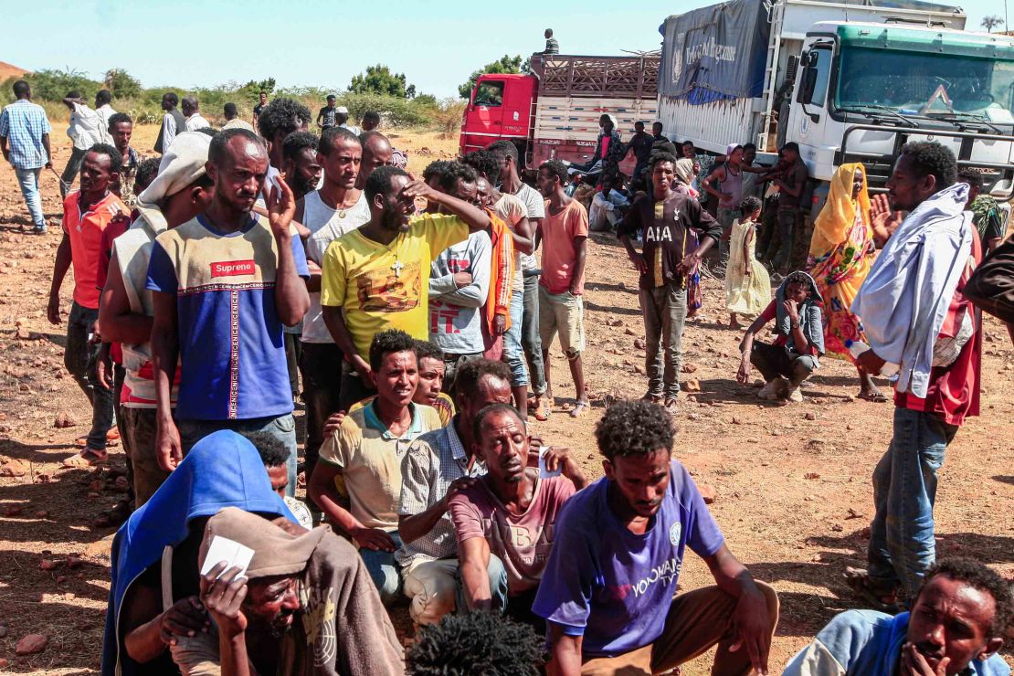 Ethiopian refugees fleeing Tigray line up to receive supplies at the Um Rakuba camp in Sudan's eastern Gedaref province, on November 16, 2020.