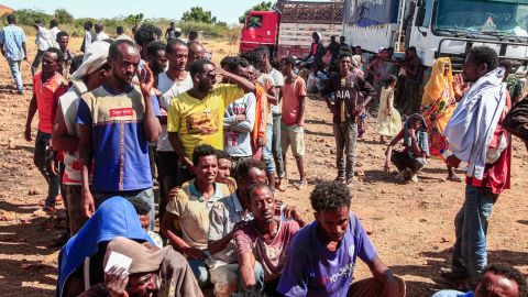 Ethiopian refugees fleeing fighting in Tigray province line up to receive supplies at the Um Rakuba camp in Sudan's eastern Gedaref province, on November 16.