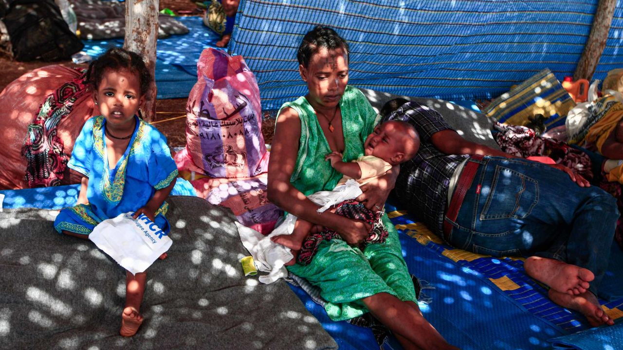 An Ethiopian refugee holds a child as she sits in a hut at the Um Rakuba camp in Sudan's eastern Gedaref province on November 16.