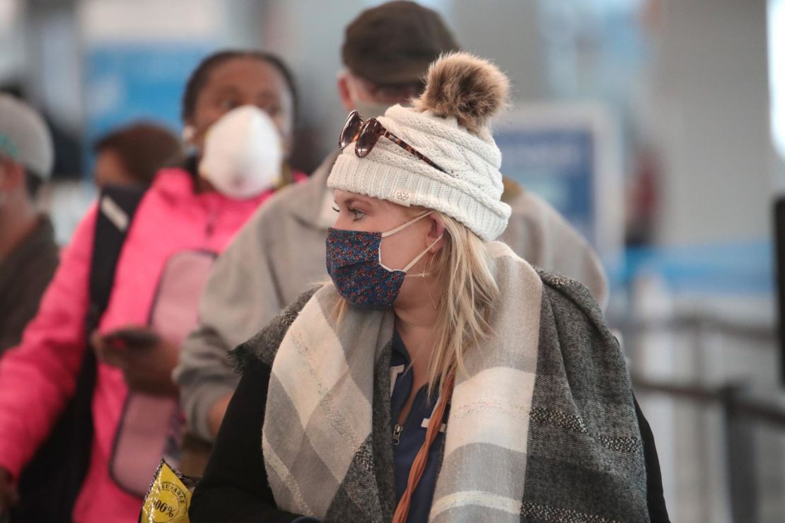 Passengers wait in line at O'Hare International Airport in Chicago on October 19, the day after the total number of passengers screened by the TSA in a day reached one million for the first time since March.