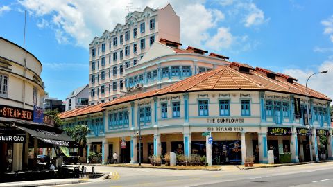 Singapore - March 19th 2019: Street scene in historic Geylang with The Sunflower Hotel against tropical sky