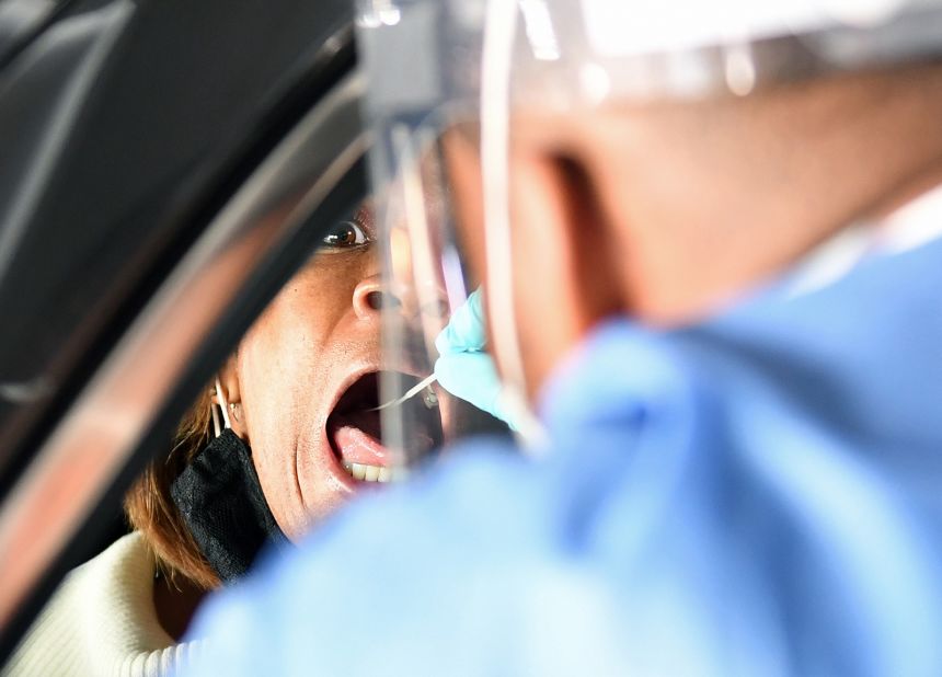 Spc. Demetrie Barnett of the Nevada National Guard administers a Covid-19 test to North Las Vegas City Councilwoman Pamela Goynes-Brown during a preview of a free drive-thru testing site on November 12.