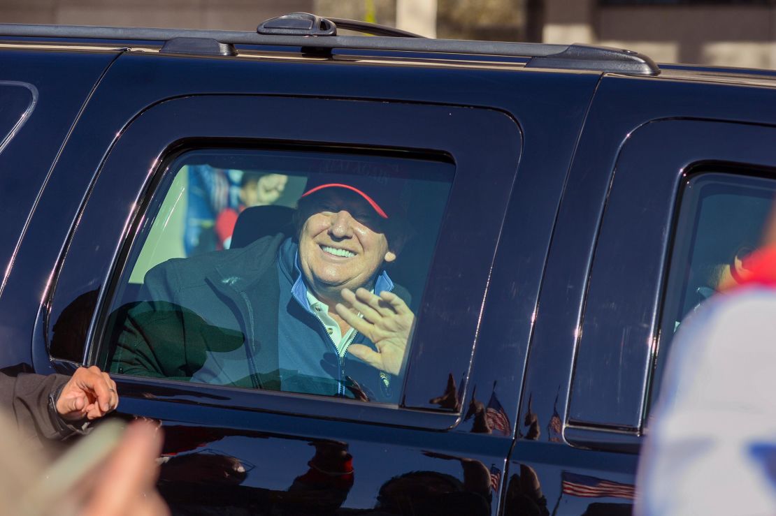 Trump waves to supporters protesting the results of the presidential election, as the presidential motorcade drives by the "Million MAGA March" rally, at Freedom Plaza in Washington on Saturday, November 14.