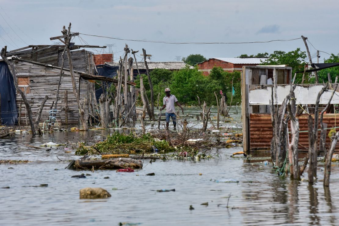An inhabitant of the Nuevo Paraiso neighborhood on the island of Belen walks on a flooded area after the passage of Hurrican Iota on November 17, 2020 in Cartagena, Colombia.