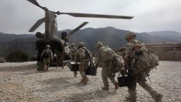 US soldiers board an Army Chinook transport helicopter after it brought fresh soldiers and supplies to the Korengal Outpost on October 27, 2008 in the Korengal Valley, Afghanistan. 