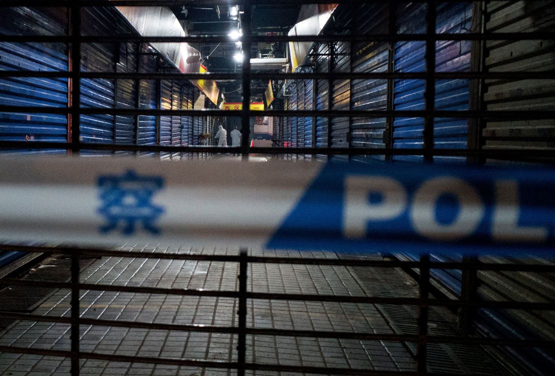 Members of staff of the Wuhan Hygiene Emergency Response Team conduct searches on the closed Huanan Seafood Wholesale Market in the city of Wuhan, in the Hubei Province, on January 11, where the Wuhan health commission said at the time that the man who died from a respiratory illness had purchased goods.