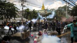 BANGKOK, THAILAND - NOVEMBER 17: Protesters react after police fired tear gas and water canon to try and disperse them outside Parliament on November 17, 2020 in Bangkok, Thailand. The demonstrators gathered outside parliament, on Tuesday, as the Thai government met to discuss amendments to the country's constitution. (Photo by Lauren DeCicca/Getty Images)