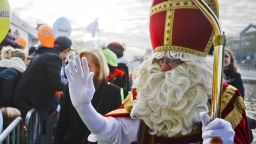 A man disguised as Saint-Nicholas (Saint-Nicolas in French and Sinterklaas in Dutch) waves upon his arrival in Brussels harbour, on November 27, 2013. The Saint Nicholas is a tradition, mostly celebrated in the Netherlands and Belgium, where children who behaved well during the year receive gifts and candy on the sixth of December. AFP PHOTO / BELGA / LAURIE DIEFFEMBACQ
=Belgium Out=        (Photo credit should read LAURIE DIEFFEMBACQ/AFP via Getty Images)