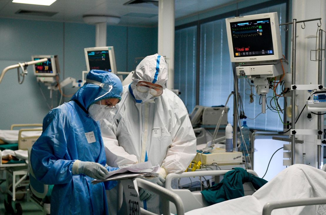 Doctors wearing personal protective equipment work with a patient at a temporary medical facility established for Covid-19 patients in Moscow, Russia.