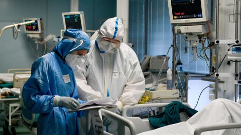 Doctors wearing personal protective equipment work with a patient at a temporary medical facility established for Covid-19 patients in Moscow, Russia.