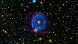 Located 6,300 light-years away in the constellation Hercules, the Blue Ring Nebula is thought to be a short-lived phase after the merger of two stars. As debris from the stellar merger was blown outward, it led to the creation of a shock front, in which hydrogen atoms were excited and induced to glow with visible light, shown in pink. The shock front, and a reverse shock wave moving inward from the shock front, also caused hydrogen molecules (as opposed to atoms) to become excited and glow with ultraviolet light, indicated in blue.
Credit: NASA/JPL-Caltech/M. Seibert (Carnegie Institution for Science)/K. Hoadley (Caltech)/GALEX Team