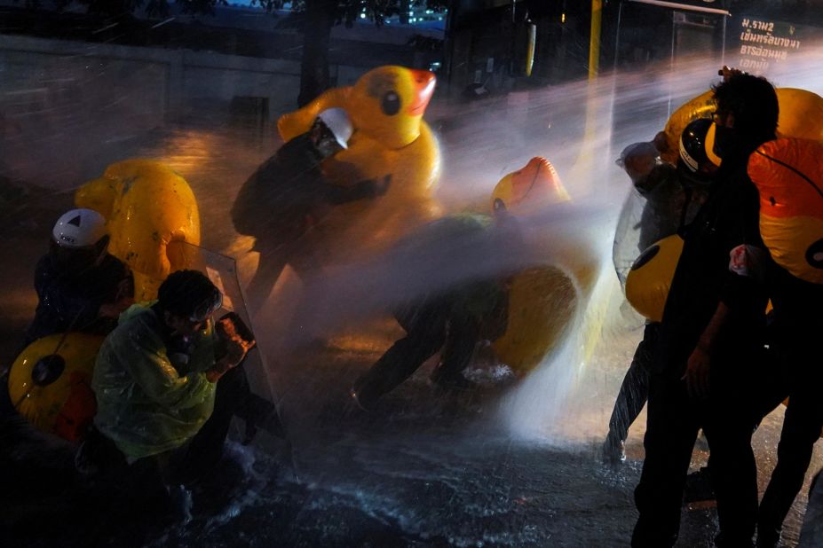Demonstrators use inflatable rubber ducks as shields to protect themselves from water cannons during a demonstration outside the parliament in Bangkok, as lawmakers debate constitutional changes, on November 17.
