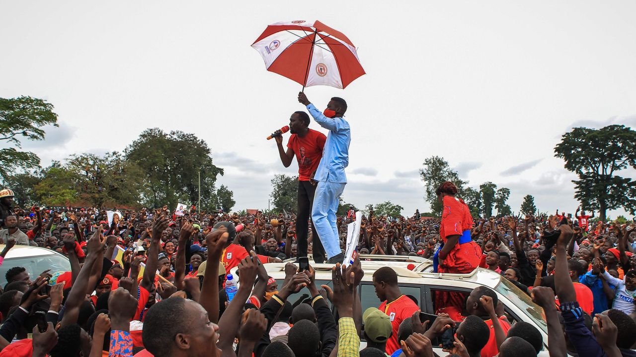 Wine holds an umbrella as he was introduced to supporters during his presidential rally before his  arrest in Luuka, Uganda, on November 18, 2020. 