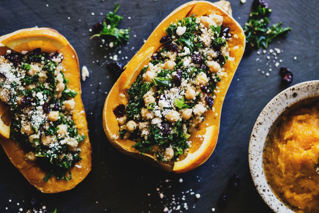 Stuffed squashes with quinoa, kale, cranberries, and chickpeas are a colorful addition to the holiday table.