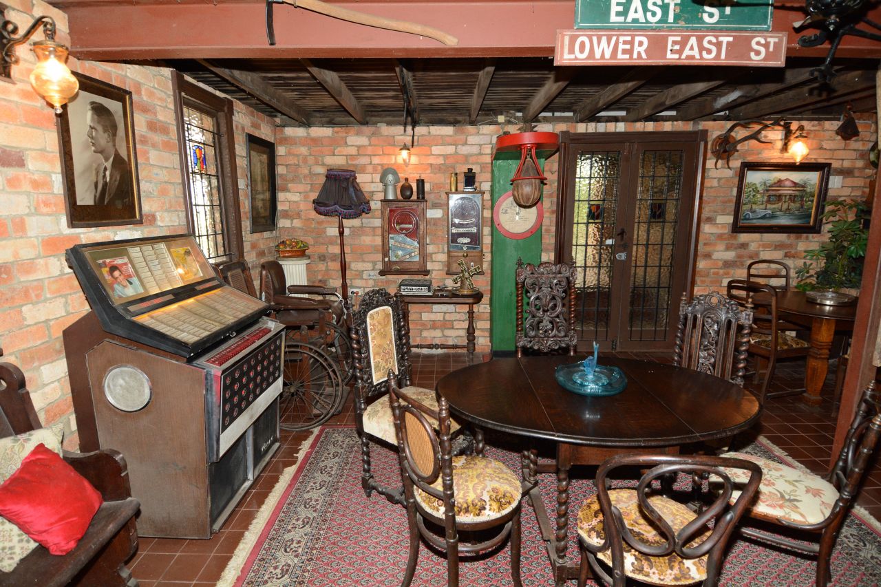 On the left sat a Rowe Ami jukebox from the 1960s, advertising hits of the era from Elvis Presley and Dean Martin. Along the back wall, a coin-operated punch strength tester invited users to pull the ball down gently, then take a "good straight punch."