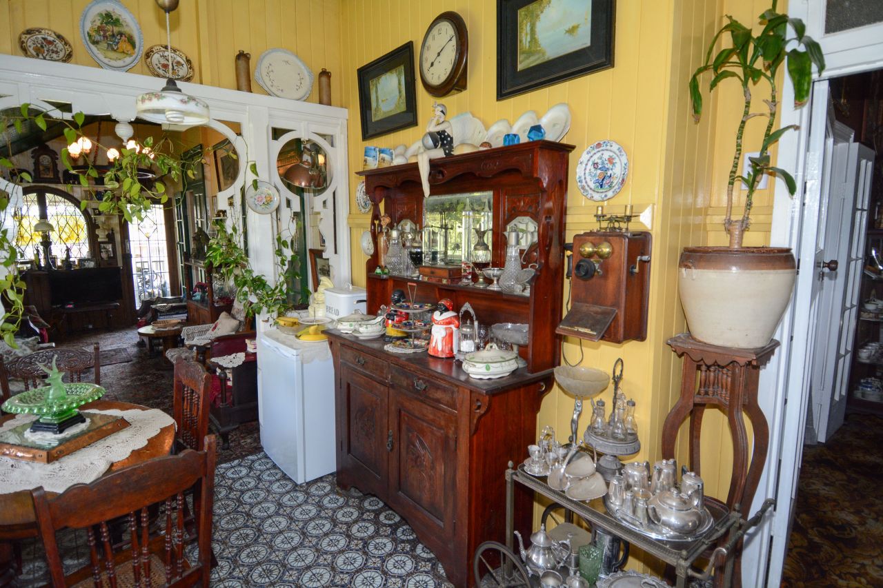 A wooden antique phone hung on the kitchen wall. Dean Brough said there was another one downstairs -- the family used them like an intercom system.