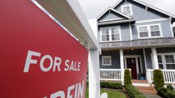 FILE - In this April 1, 2020 photo, a "For Sale" sign stands in front of a home that is in the process of being sold in Monroe, Wash., outside of Seattle.  U.S. average rates on long-term mortgages rose slightly this week but remain at historically low levels. Mortgage buyer Freddie Mac reported Thursday, Sept. 24,  that the average rate on the 30-year home loan edged up to 2.90% from 2.87% last week.   (AP Photo/Elaine Thompson, File)