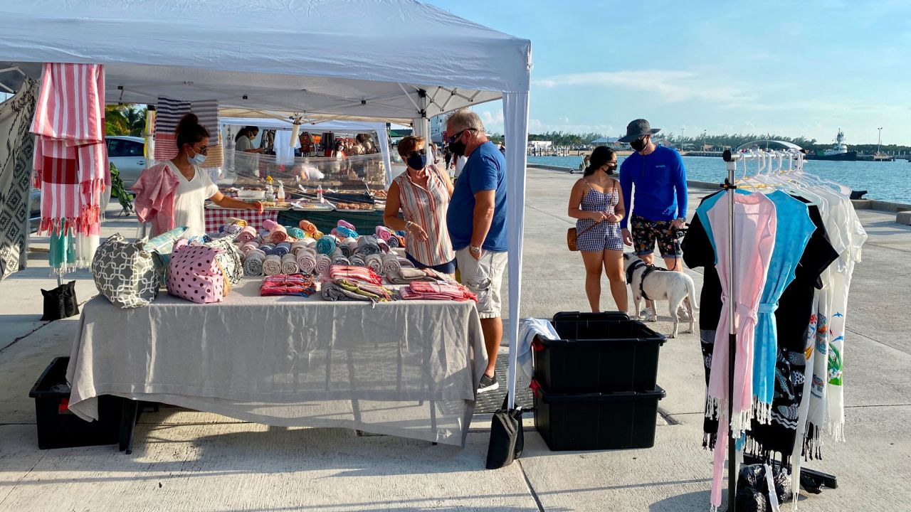 Customers and vendors wear masks at a farmers' market in Key West, Florida, on September 17.