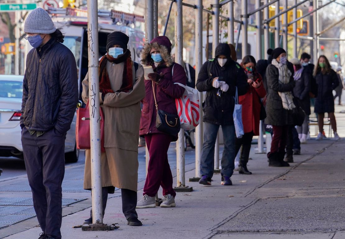 People wait in a line stretching around a block outside an urgent care clinic offering Covid-19 testing in Brooklyn, New York, on Wednesday.