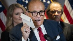 WASHINGTON, DC - NOVEMBER 19: Rudy Giuliani holds up a mail-in ballot as he speaks to the press about various lawsuits related to the 2020 election,  inside the Republican National Committee headquarters on November 19, 2020 in Washington, DC. President Donald Trump, who has not been seen publicly in several days, continues to push baseless claims about election fraud and dispute the results of the 2020 United States presidential election. (Photo by Drew Angerer/Getty Images)