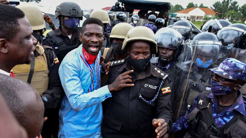 Ugandan presidential candidate Robert Kyagulanyi also known as Bobi Wine is led into a vehicle by riot policemen in Luuka district, eastern Uganda November 18, 2020. REUTERS/Abubaker Lubowa