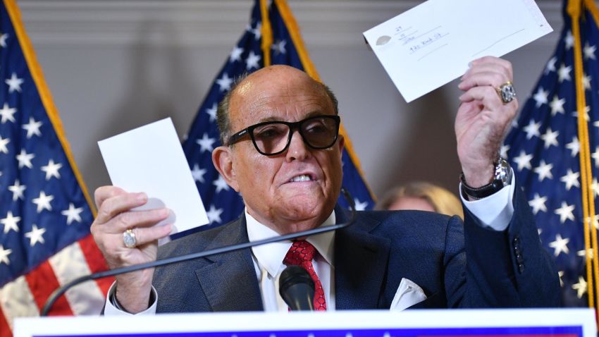 Trump's personal lawyer Rudy Giuliani holds a ballot envelope as he speaks during a press conference at the Republican National Committee headquarters in Washington, DC, on November 19, 2020. (Photo by MANDEL NGAN / AFP) (Photo by MANDEL NGAN/AFP via Getty Images)