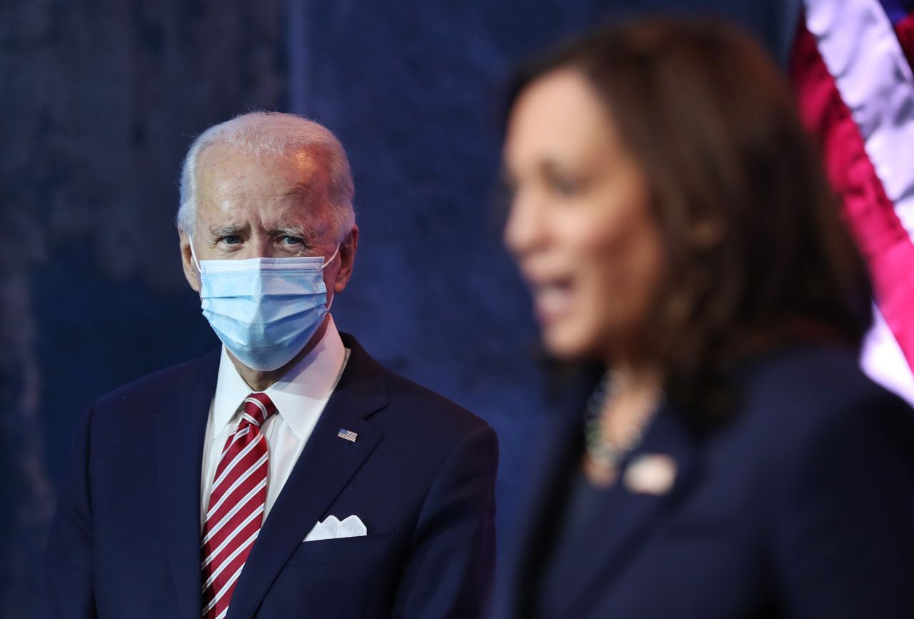 US President-elect Joe Biden look on as Vice President-elect Kamala Harris delivers remarks on the US economy at the Queen Theater in Wilmington, Delaware, on Monday, November 16. Biden is following through with his transition plans despite Trump's refusal to concede the race.