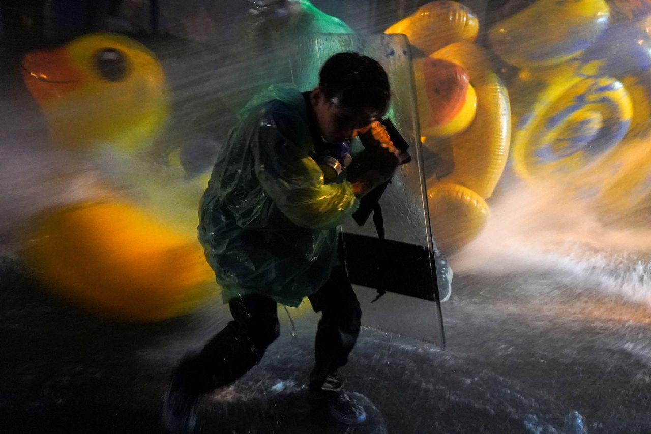 A demonstrator uses a shield to protect against water cannons during an <a href="https://www.cnn.com/2020/10/16/asia/gallery/thailand-protests/index.html" target="_blank">anti-government protest</a> in Bangkok, Thailand, on Tuesday, November 17. Protesters brought giant yellow inflatable ducks to use as shields.