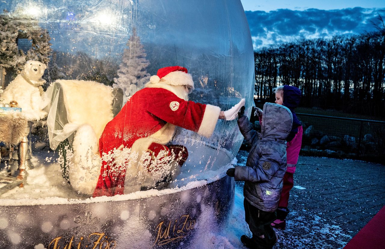 A person dressed as Santa Claus meets with children from inside a "Santa Claus bubble" at Aalborg Zoo in Denmark on Friday, November 13.