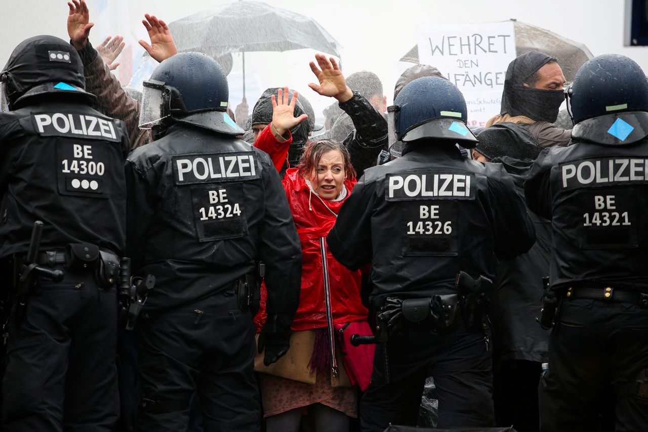 Demonstrators put up their hands during a protest against coronavirus restrictions in Berlin on Wednesday, November 18.
