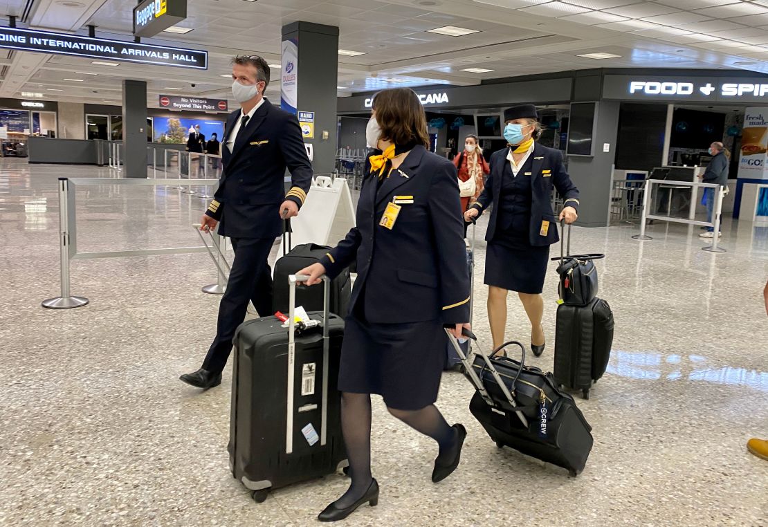 Airline crew members and travelers at Washington Dulles International Airport on November 19, 2020.