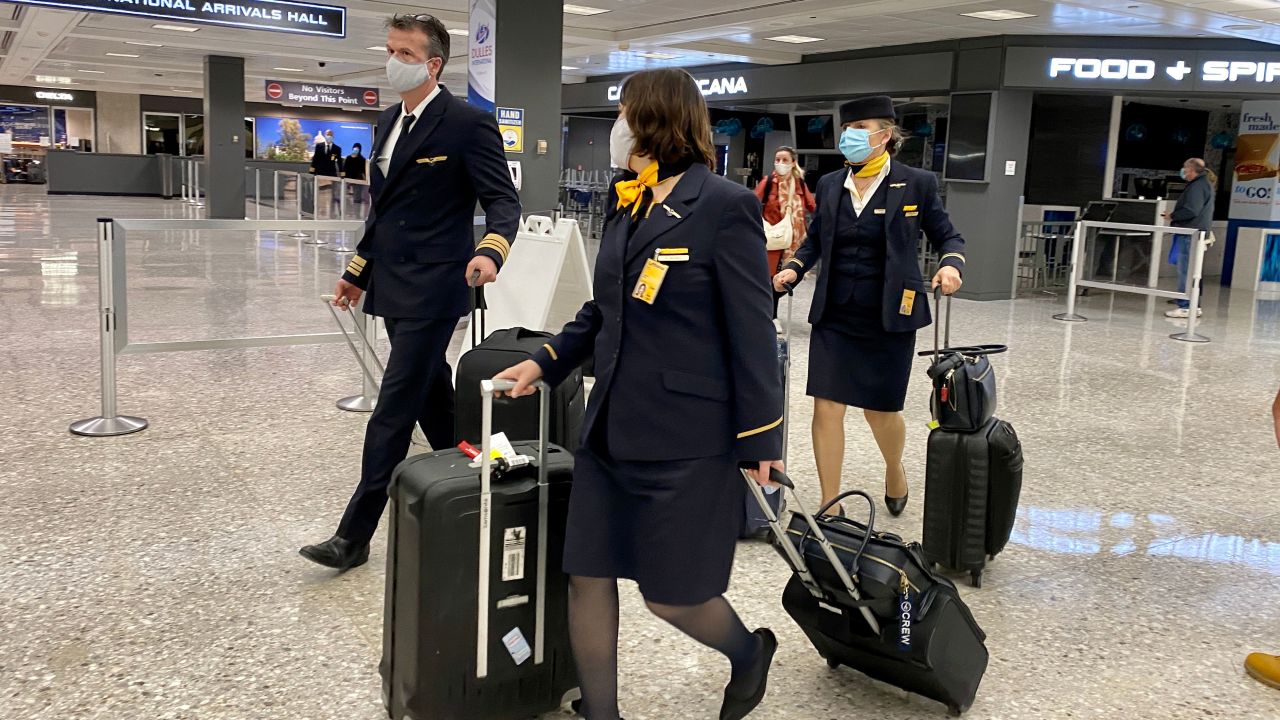 Airline crew members and travelers at Washington Dulles International Airport on November 19, 2020.