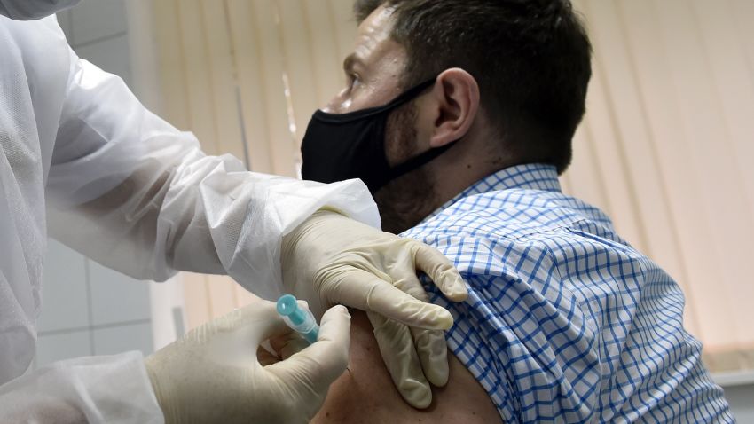 A nurse inoculates volunteer Ilya Dubrovin, 36, with Russia's new coronavirus vaccine in a post-registration trials at a clinic in Moscow on September 10, 2020. - Russia announced last month that its vaccine, named "Sputnik V" after the Soviet-era satellite that was the first launched into space in 1957, had already received approval. The vaccine was developed by the Gamaleya research institute in Moscow in coordination with the Russian defence ministry. (Photo by Natalia KOLESNIKOVA / AFP) (Photo by NATALIA KOLESNIKOVA/AFP via Getty Images)