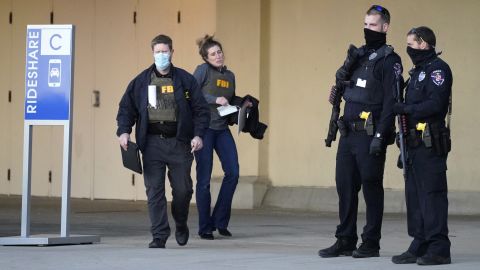 Police and FBI agents investigate the shooting at Mayfair Mall in Wauwatosa, Wisconsin, on Friday.