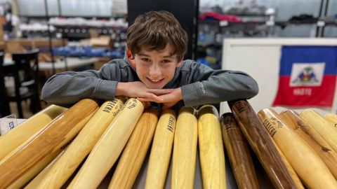 Tommy Rhomberg and his bats, which he carves out of trees brought down by a powerful derecho.
